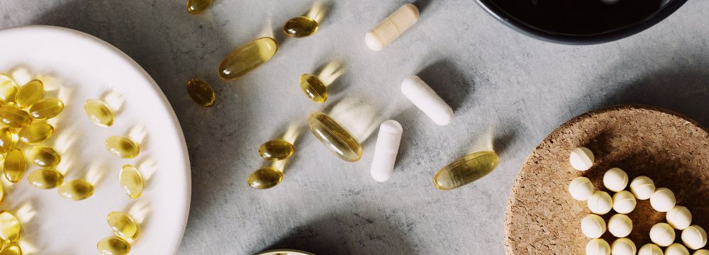 Vitamins scattered on table and in bowls