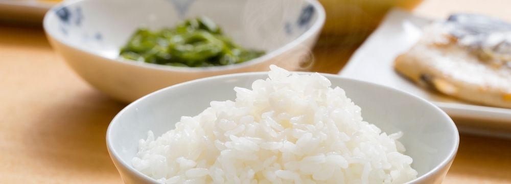 Bowl of rice, among other foods, on kitchen table