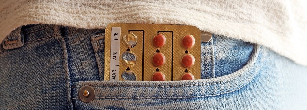  Hormone pills sticking out of front jean pocket 
